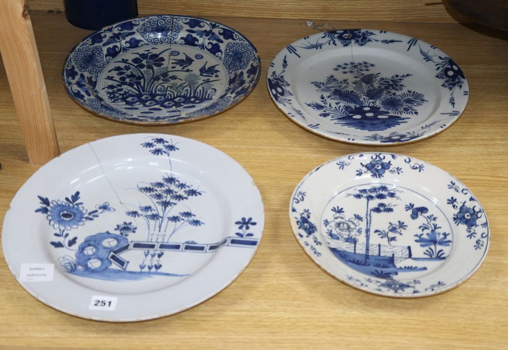 Four 18th century Delft blue and white dishes, largest 35cm (a.f.)